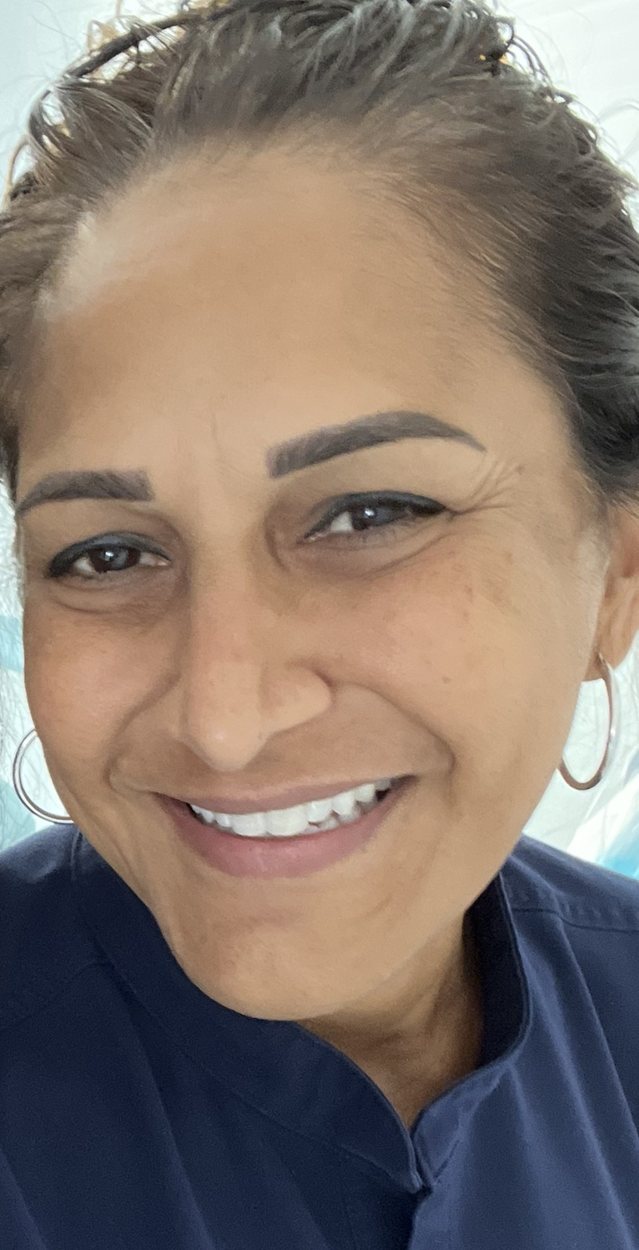 Your AFA provider smiling, wearing navy scrubs